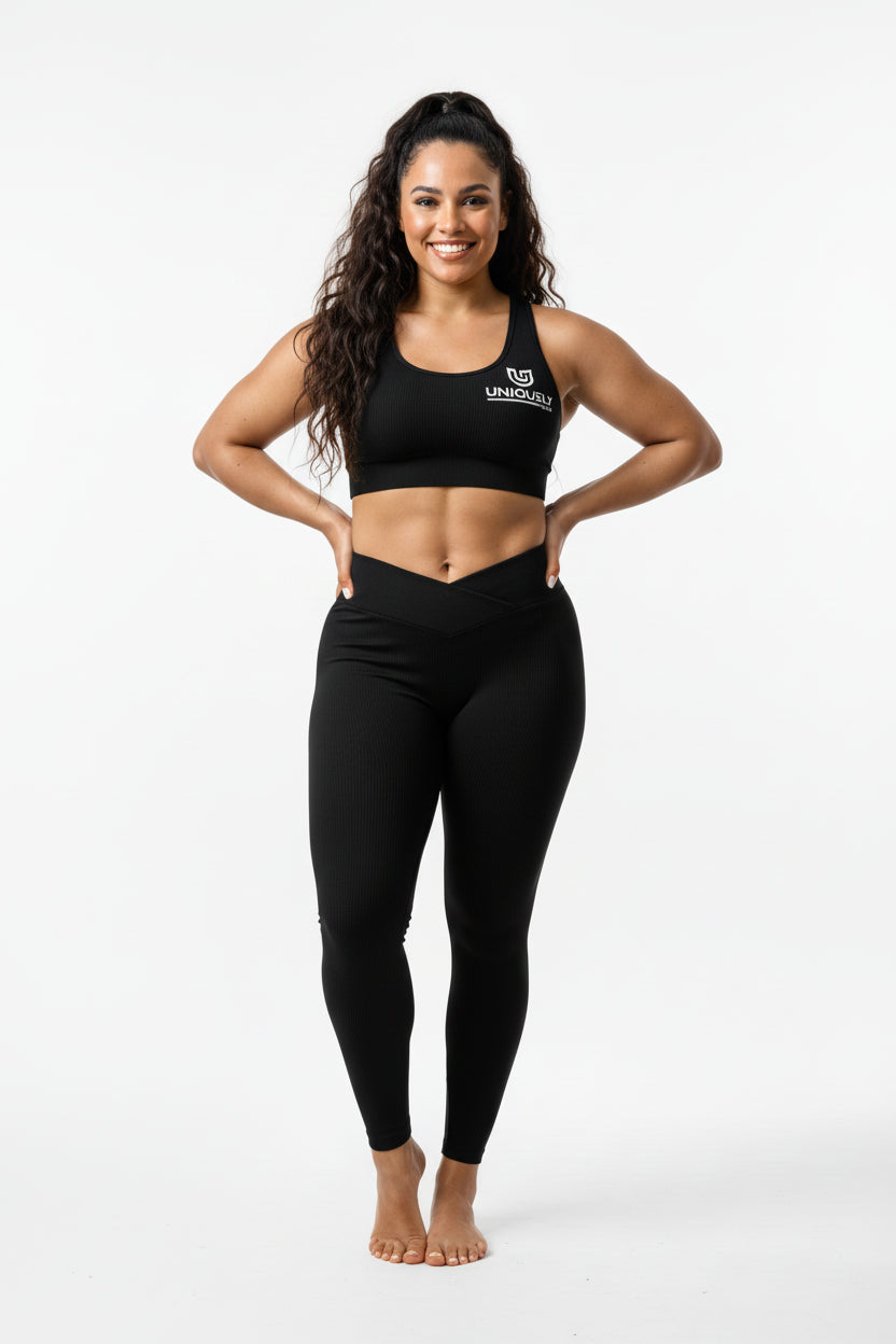 Women’s black rippled workout set with crossover high-waist leggings that slim the waist and enhance curves, paired with an adjustable cross-strap back sports bra for a sculpted, supportive, and sleek athletic look.