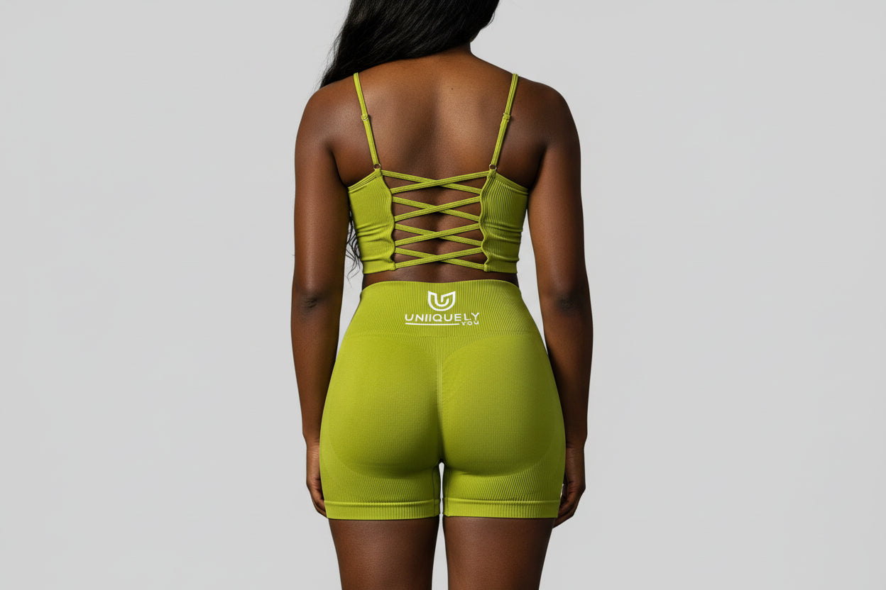 Women’s olive green rippled shorts set featuring high-waisted sculpting biker shorts with butt-lifting design and a strappy adjustable crisscross back sports bra, designed to enhance curves, smooth cellulite, and deliver a flattering, confident athletic look.