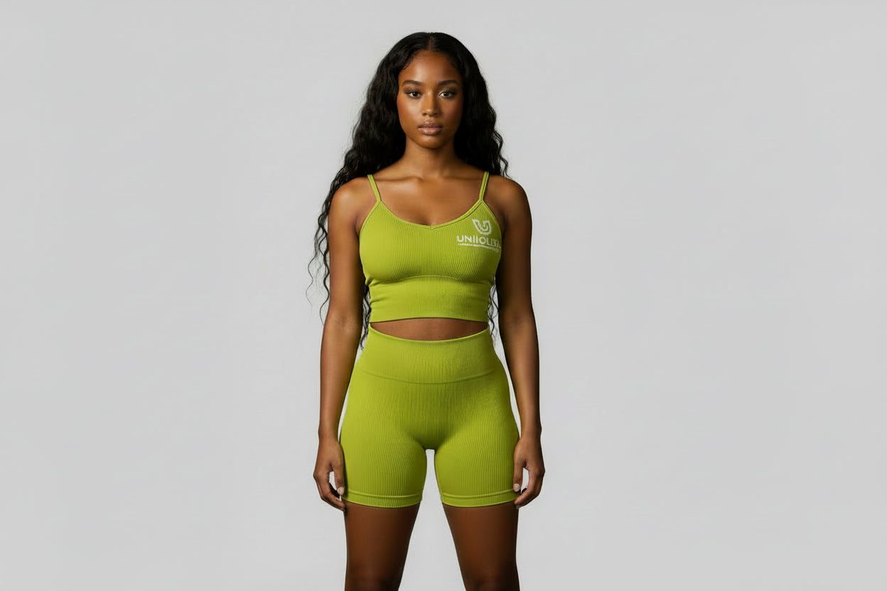 Women’s olive green rippled shorts set featuring high-waisted sculpting biker shorts with butt-lifting design and a strappy adjustable crisscross back sports bra, designed to enhance curves, smooth cellulite, and deliver a flattering, confident athletic look.