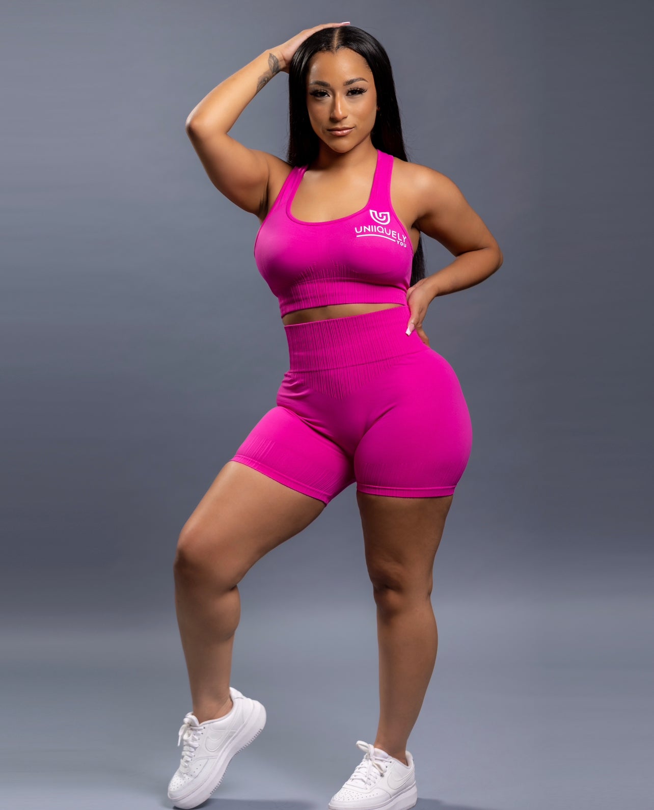 Pink seamless workout shorts set with high-waisted butt lifting shorts and supportive sports bra, designed for a sculpted fit, waist slimming, and smooth