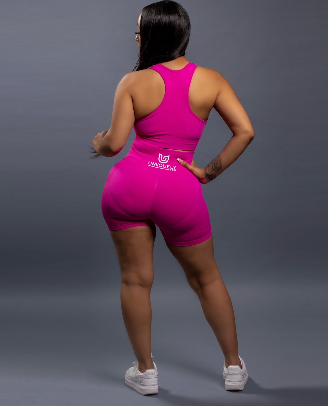 Pink seamless workout shorts set with high-waisted butt lifting shorts and supportive sports bra, designed for a sculpted fit, waist slimming, and smooth