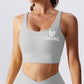 Grey rippled cross-back sports bra with seamless design, supportive fit, breathable fabric, and stylish strappy back detail for workouts and activewear