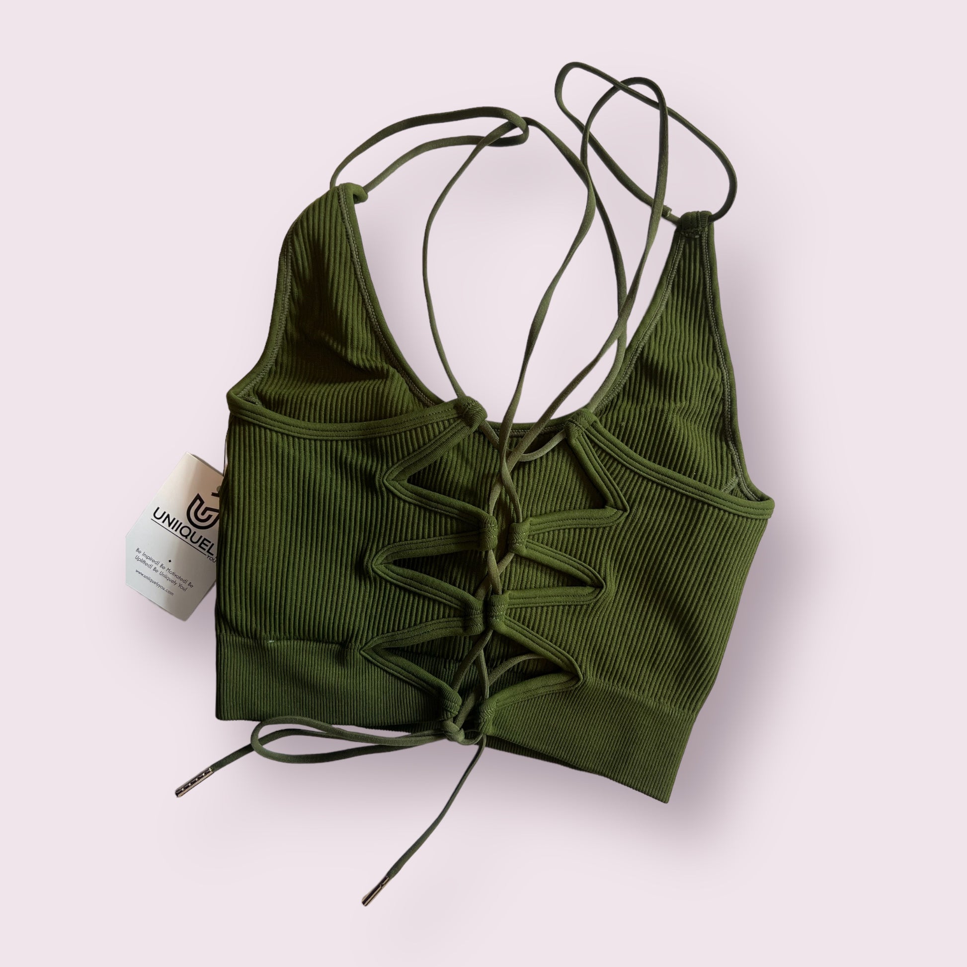 Green rippled cross-back sports bra with seamless design, supportive fit, breathable fabric, and stylish strappy back detail for workouts and activewear