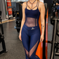 Midnight navy full-length women’s workout jumpsuit with mesh paneling, strappy neckline, and sculpting fit, ankle-length activewear for gym and training