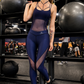 Midnight navy full-length women’s workout jumpsuit with mesh paneling, strappy neckline, and sculpting fit, ankle-length activewear for gym and training