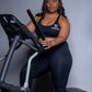 Black seamless workout set with cross-back strappy sports bra and high-waisted leggings featuring butt lifting design, waist-slimming fit, and smooth sculpting