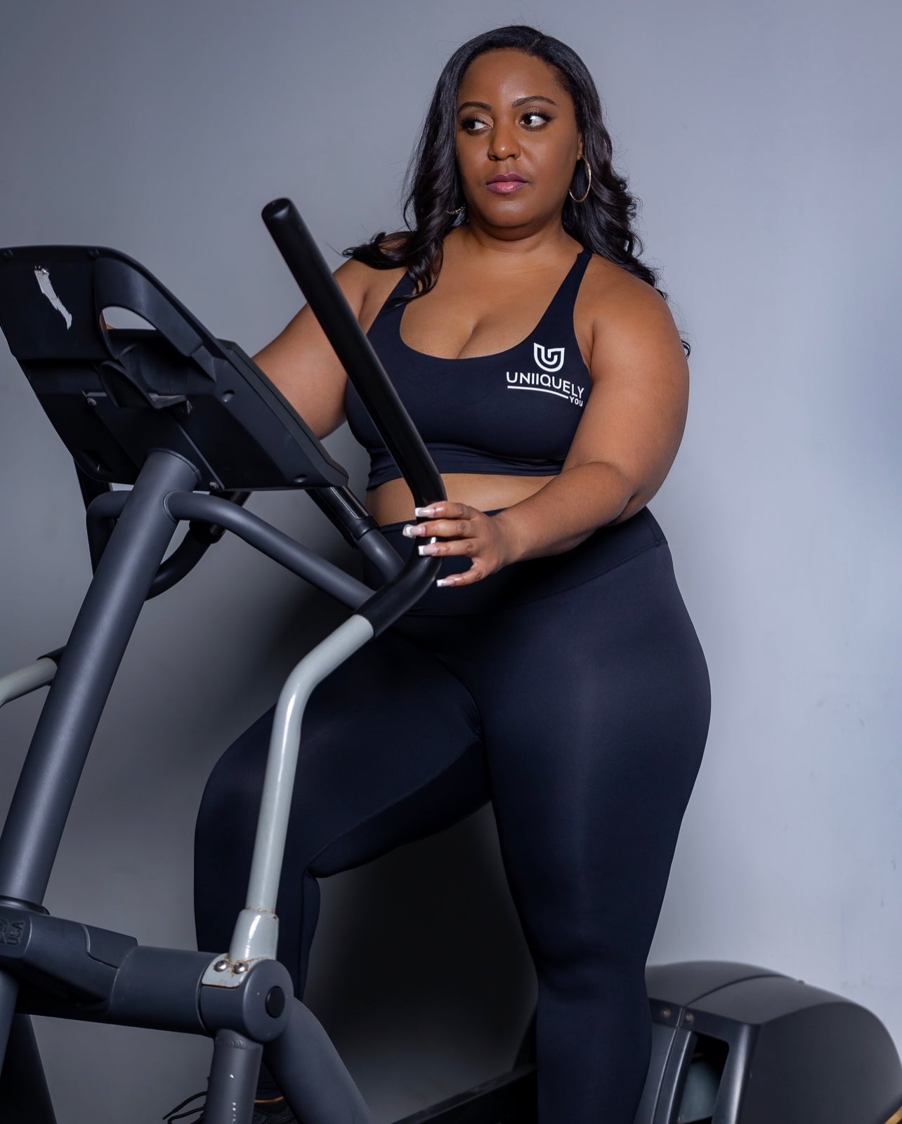 Black seamless workout set with cross-back strappy sports bra and high-waisted leggings featuring butt lifting design, waist-slimming fit, and smooth sculpting