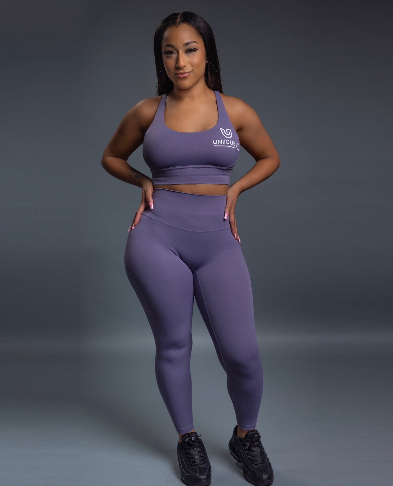 Purple Seamless workout set with cross-back sports bra and high-waisted leggings featuring butt lift design, waist-slimming fit, and smooth sculpting fabric