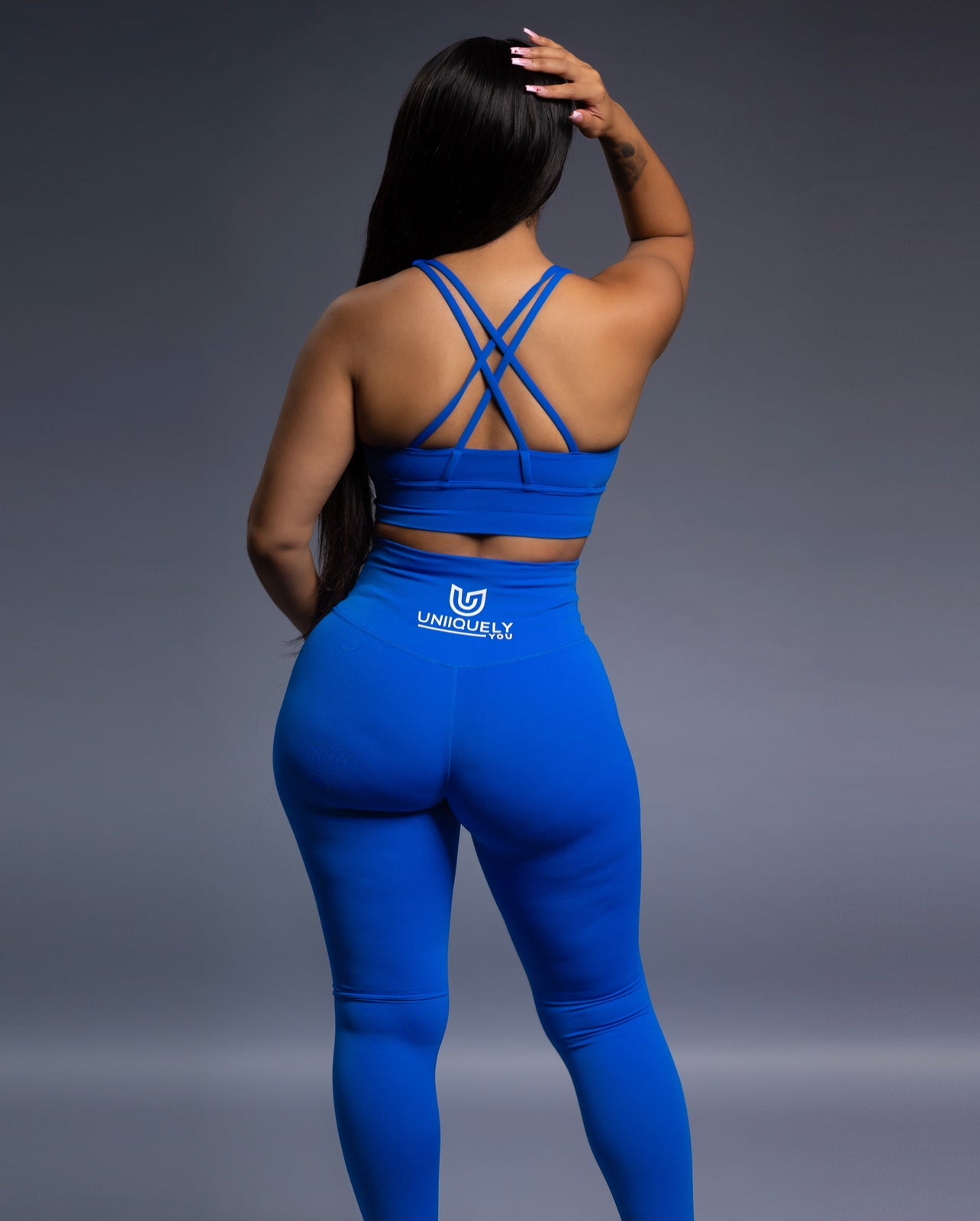 Royal blue seamless workout set with cross-back strappy sports bra and high-waisted leggings featuring butt lift design, waist-slimming fit, and smooth sculpting fabric
