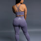 Purple seamless workout set with cross-back strappy sports bra and high-waisted leggings featuring butt lifting design, waist-slimming fit, and smooth sculpting fabric