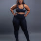 Black seamless workout set with cross-back strappy sports bra and high-waisted leggings featuring butt lifting design, waist-slimming fit, and smooth sculpting fabric