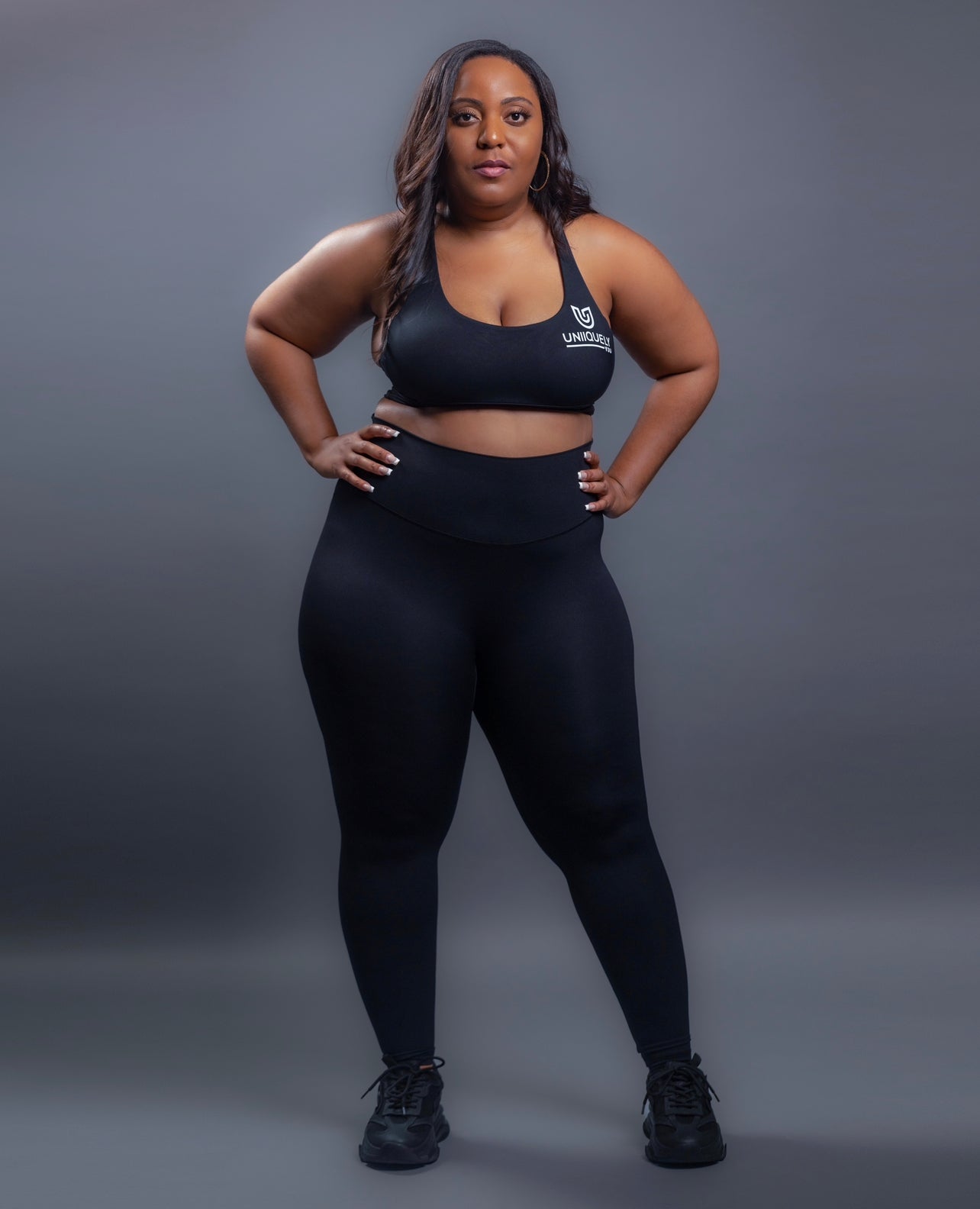 Black seamless workout set with cross-back strappy sports bra and high-waisted leggings featuring butt lifting design, waist-slimming fit, and smooth sculpting fabric