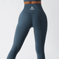 Teal blue seamless workout set with cross-back sports bra and high-waisted leggings featuring butt lift design, waist-slimming fit, and smooth sculpting fabric