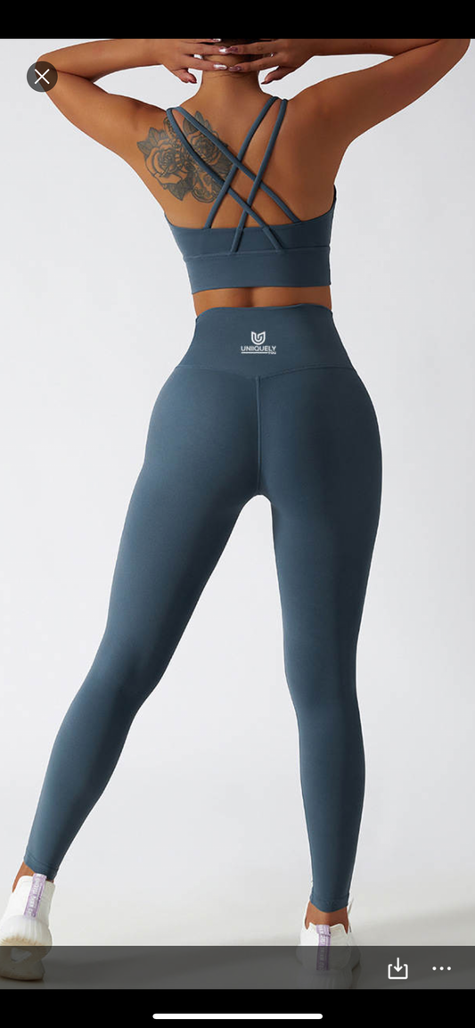 Teal blue seamless workout set with cross-back sports bra and high-waisted leggings featuring butt lift design, waist-slimming fit, and smooth sculpting fabric