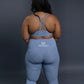 Light blue seamless workout set with cross-back sports bra and high-waisted leggings featuring butt lift design, waist-slimming fit, and smooth sculpting fabric