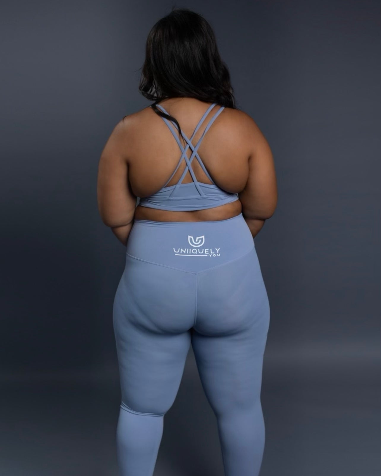 Light blue seamless workout set with cross-back sports bra and high-waisted leggings featuring butt lift design, waist-slimming fit, and smooth sculpting fabric