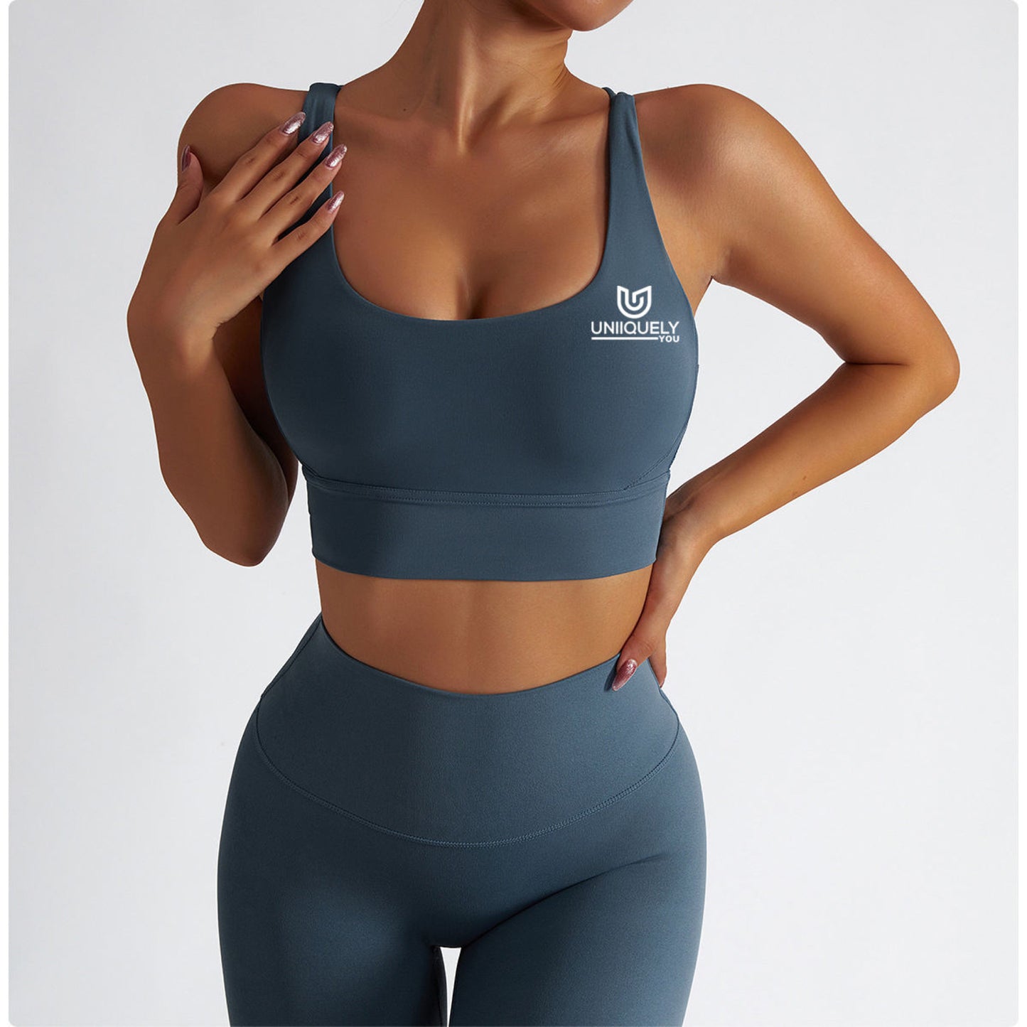 Teal blue seamless workout set with cross-back sports bra and high-waisted leggings featuring butt lift design, waist-slimming fit, and smooth sculpting fabric