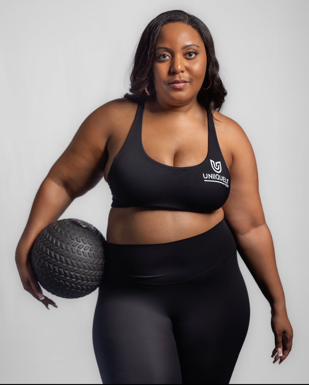 Black seamless workout set with cross-back strappy sports bra and high-waisted leggings featuring butt lifting design, waist-slimming fit, and smooth sculpting fabric