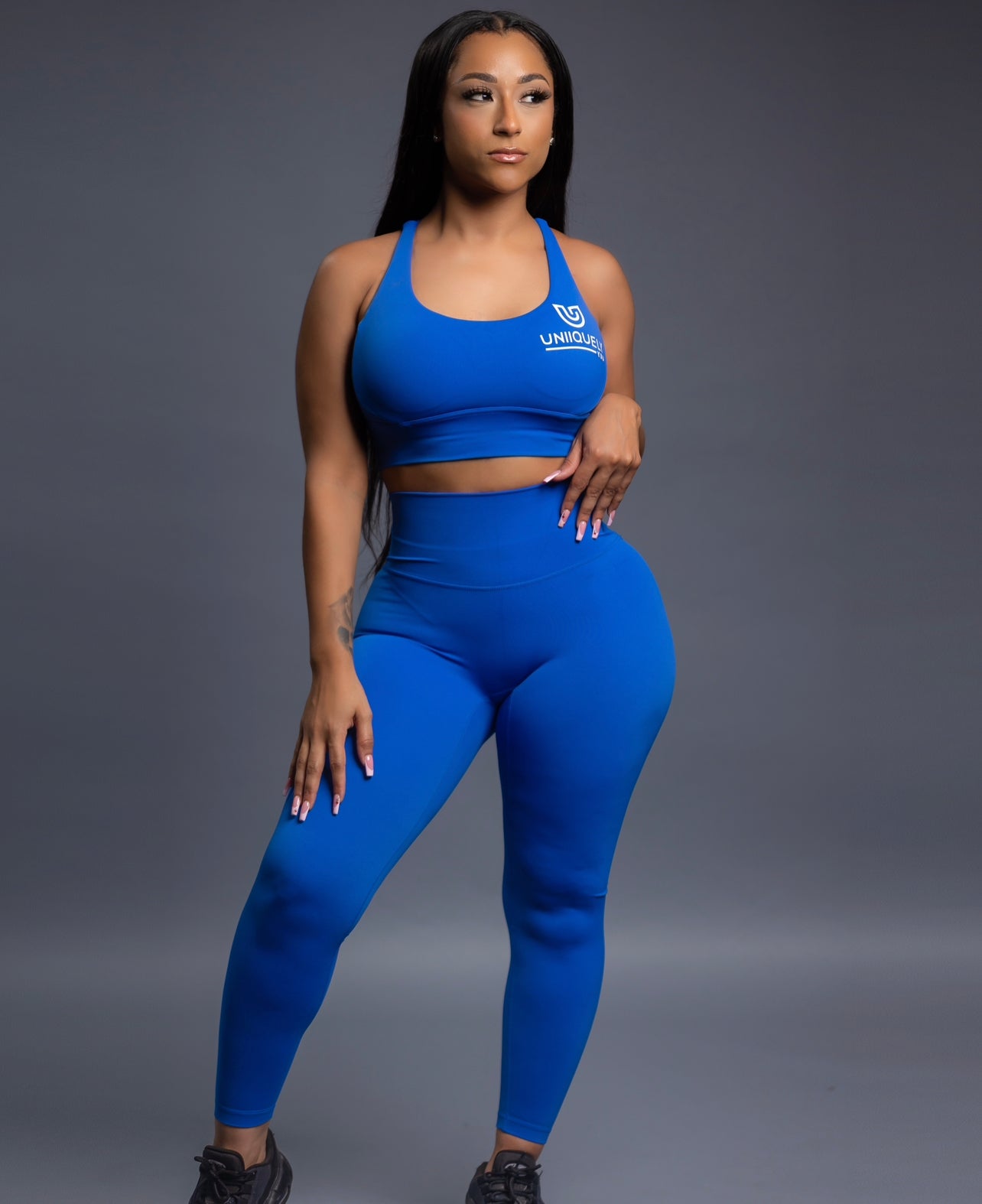 Royal blue seamless workout set with cross-back strappy sports bra and high-waisted leggings featuring butt lift design, waist-slimming fit, and smooth sculpting fabric